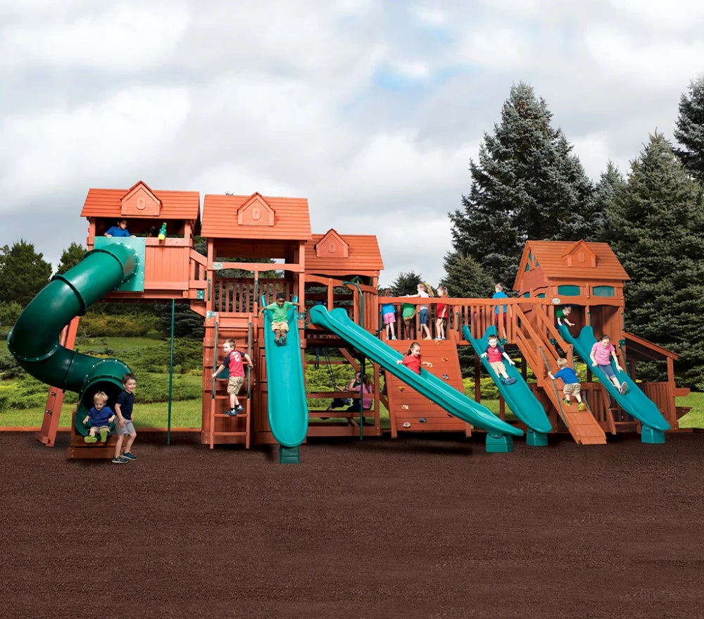 Children playing on a large wooden playground with slides and climbing structures.