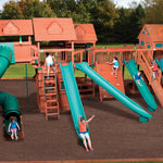 Children playing on a large wooden playground with multiple slides and climbing structures.
